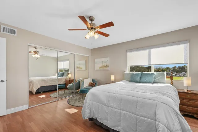 a bedroom with a large bed and a large window