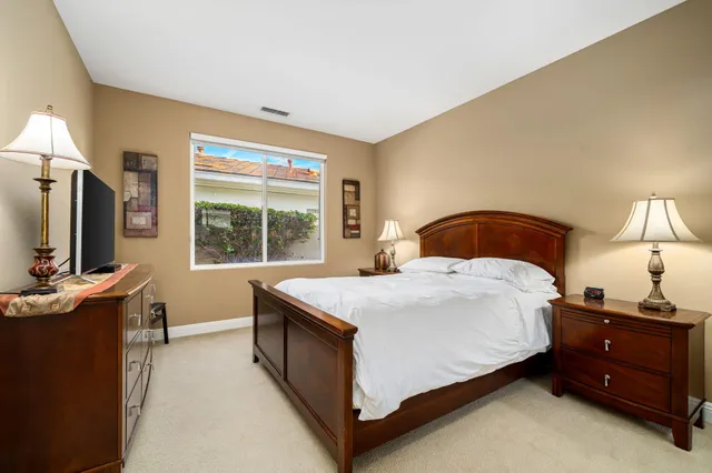 a bathroom with a double vanity sink a mirror a shower and a bathtub