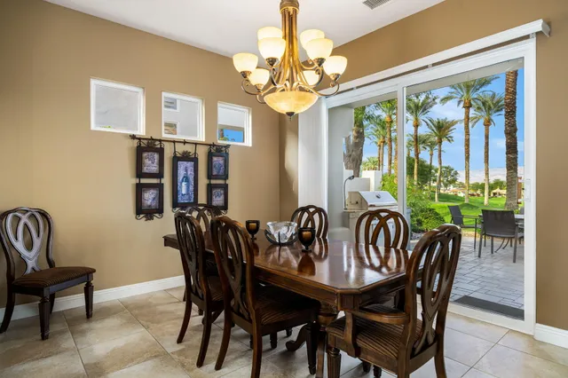 a view of a dining room with furniture wooden floor and chandelier
