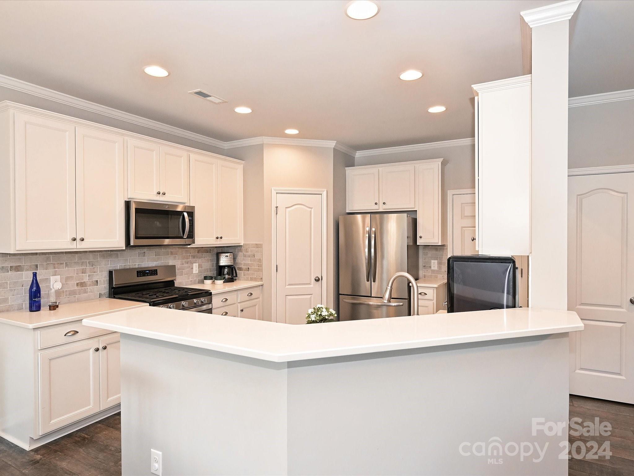 4041 Woodsmill Road Indian Land, SC 29707 - Photo 12 of 36 a kitchen with stainless steel appliances a microwave a sink and cabinets