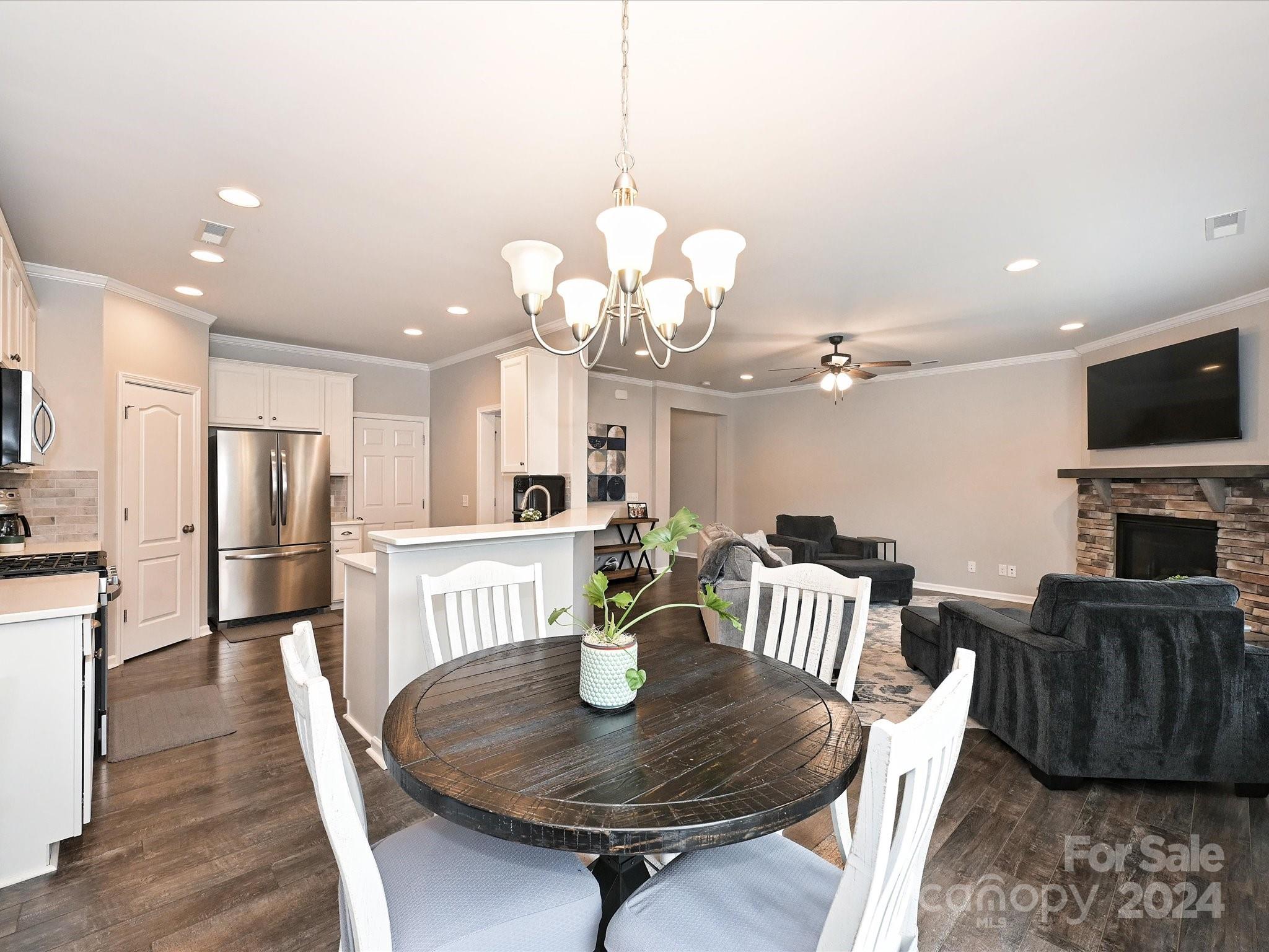 4041 Woodsmill Road Indian Land, SC 29707 - Photo 13 of 36 a view of a dining room with furniture a chandelier and wooden floor