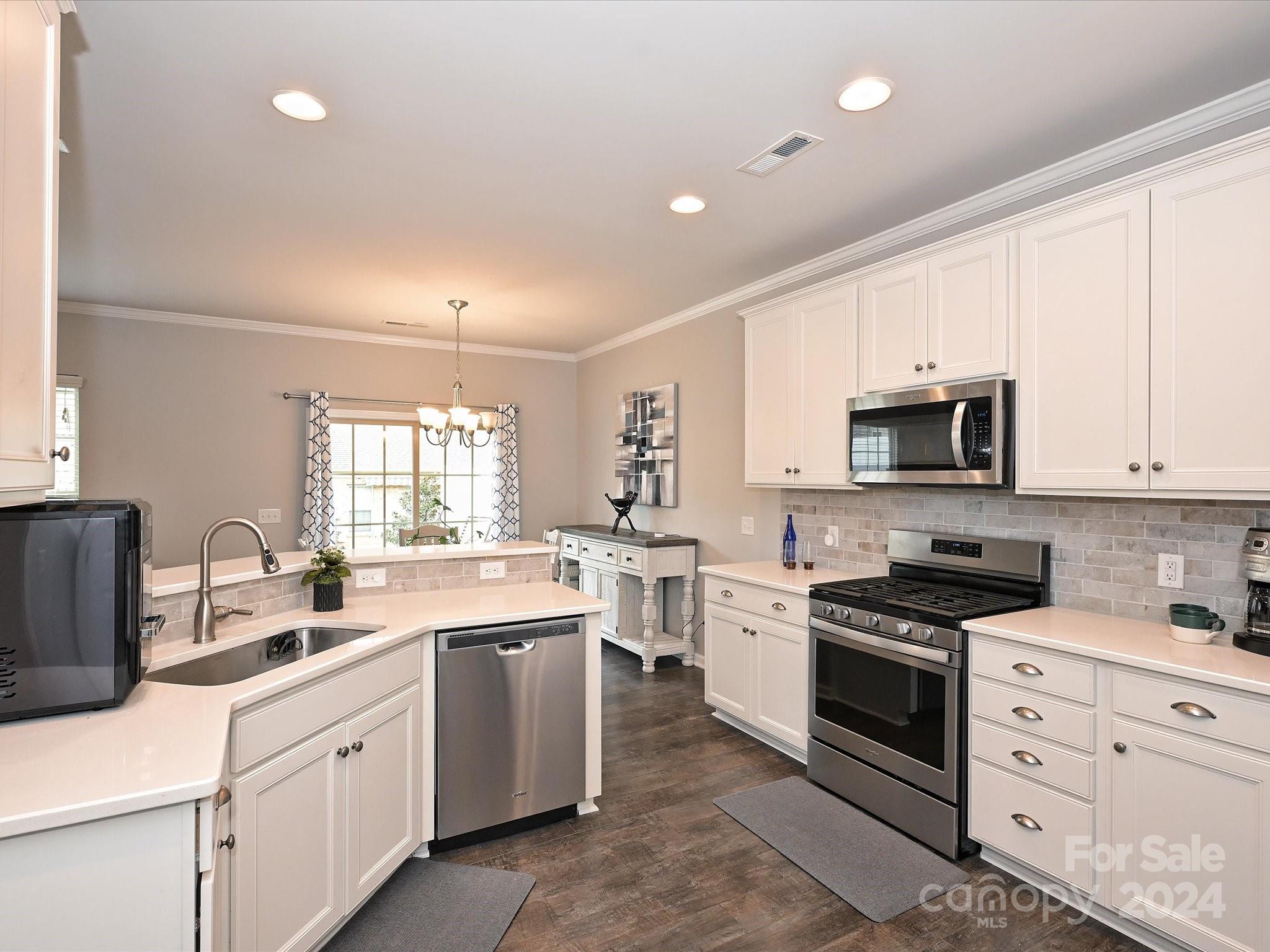 4041 Woodsmill Road Indian Land, SC 29707 - Photo 17 of 36 a kitchen with white cabinets stainless steel appliances and sink