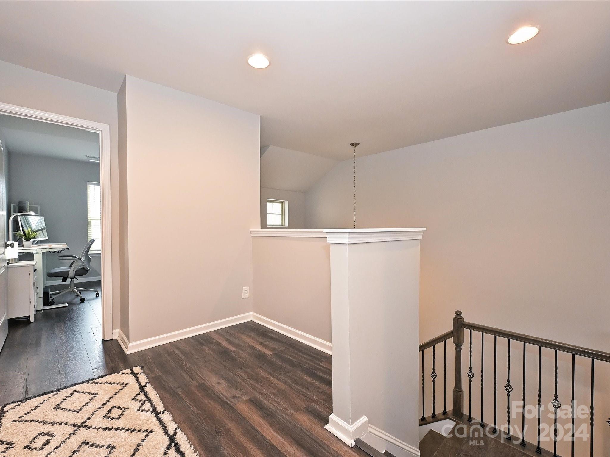 4041 Woodsmill Road Indian Land, SC 29707 - Photo 21 of 36 a view of a hallway with wooden floor and a living room