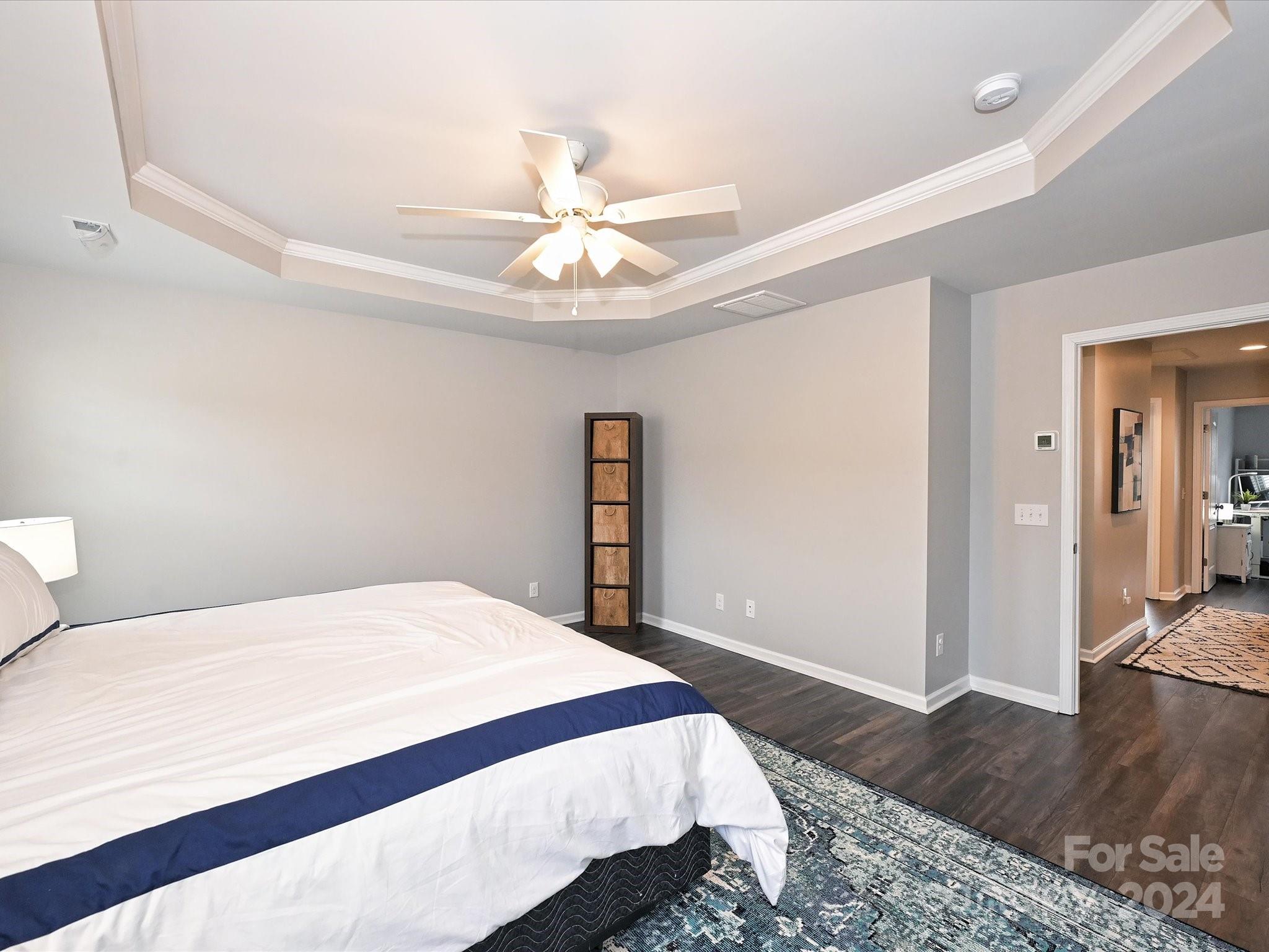 4041 Woodsmill Road Indian Land, SC 29707 - Photo 23 of 36 a bedroom with a large bed and a chandelier