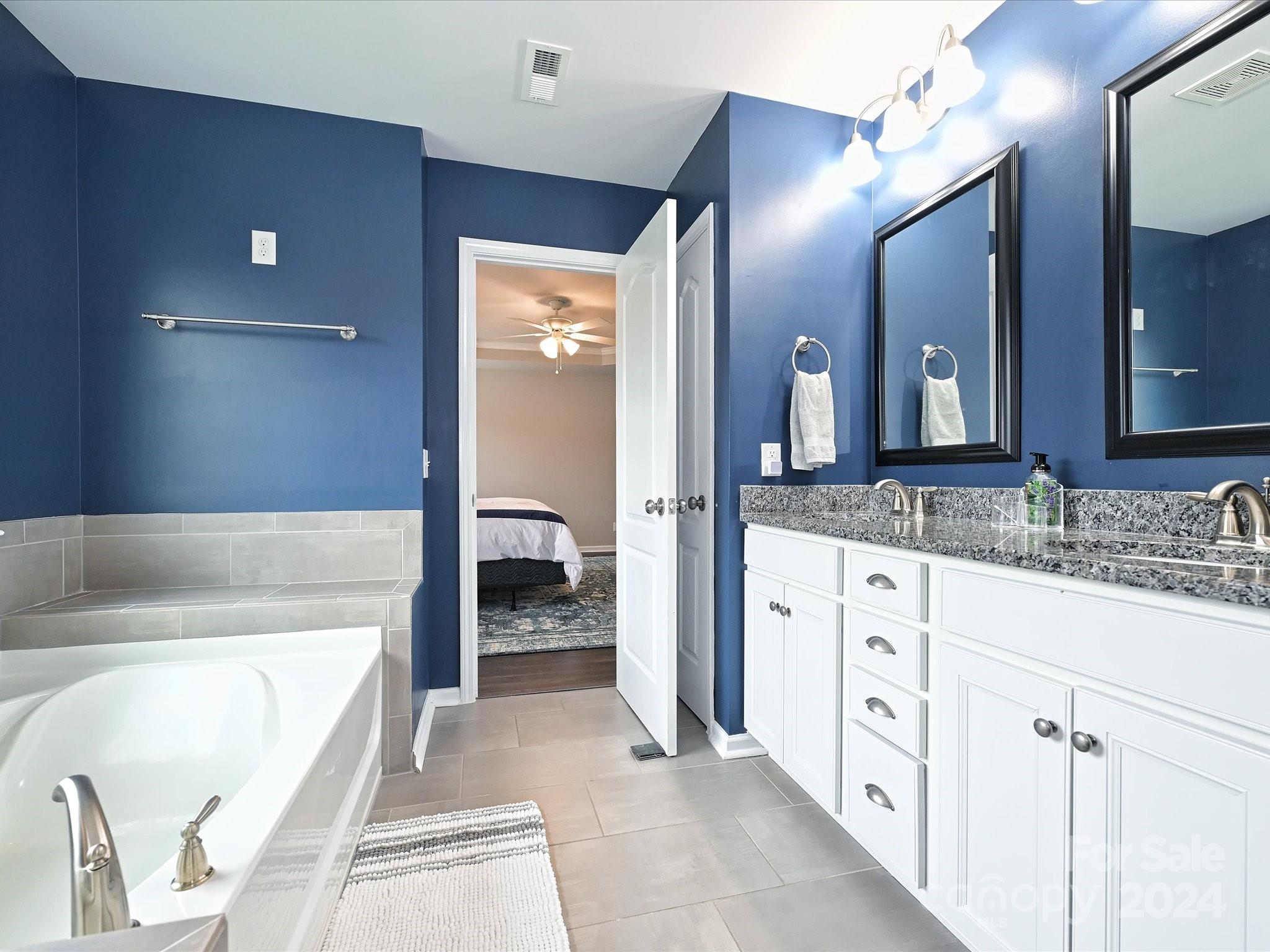 4041 Woodsmill Road Indian Land, SC 29707 - Photo 25 of 36 a spacious bathroom with a tub sink and mirror