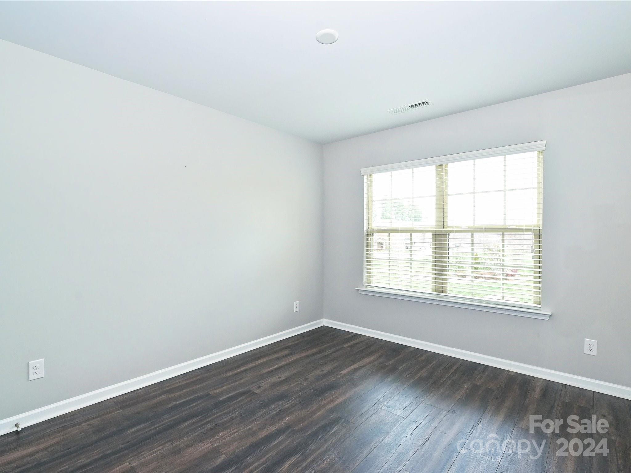 4041 Woodsmill Road Indian Land, SC 29707 - Photo 29 of 36 an empty room with wooden floor and windows