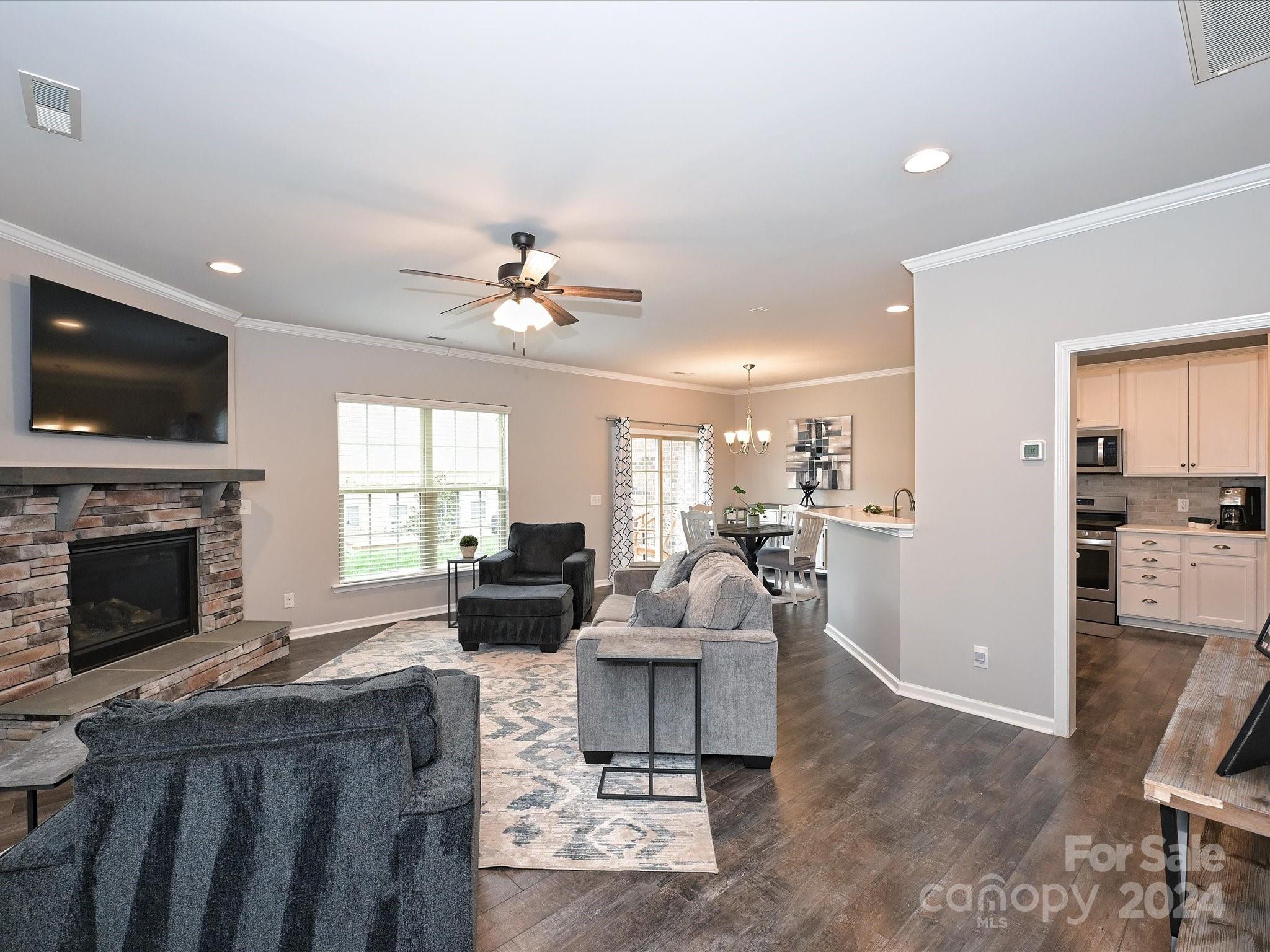 4041 Woodsmill Road Indian Land, SC 29707 - Photo 6 of 36 a living room with furniture fireplace and a flat screen tv