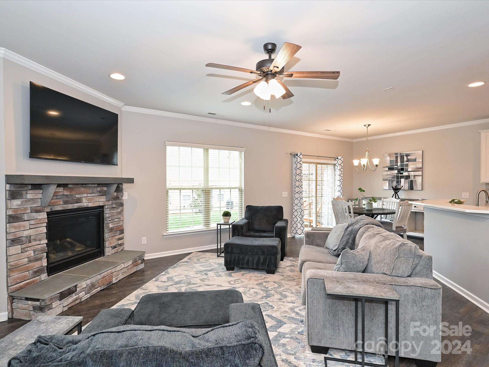 4041 Woodsmill Road Indian Land, SC 29707 - Photo 7 of 36 a living room with furniture a flat screen tv and a fireplace