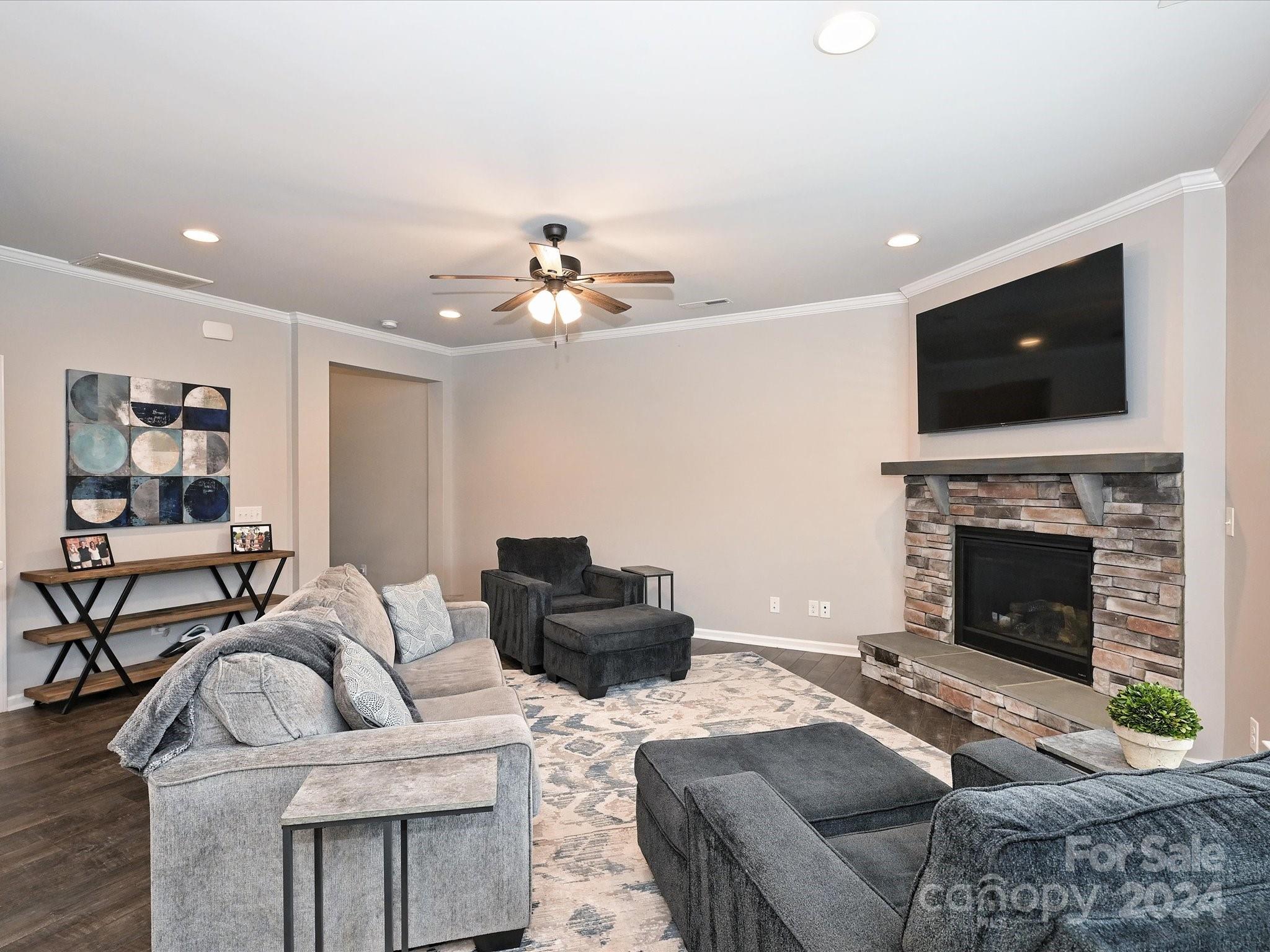 4041 Woodsmill Road Indian Land, SC 29707 - Photo 9 of 36 a living room with furniture a flat screen tv and a fireplace