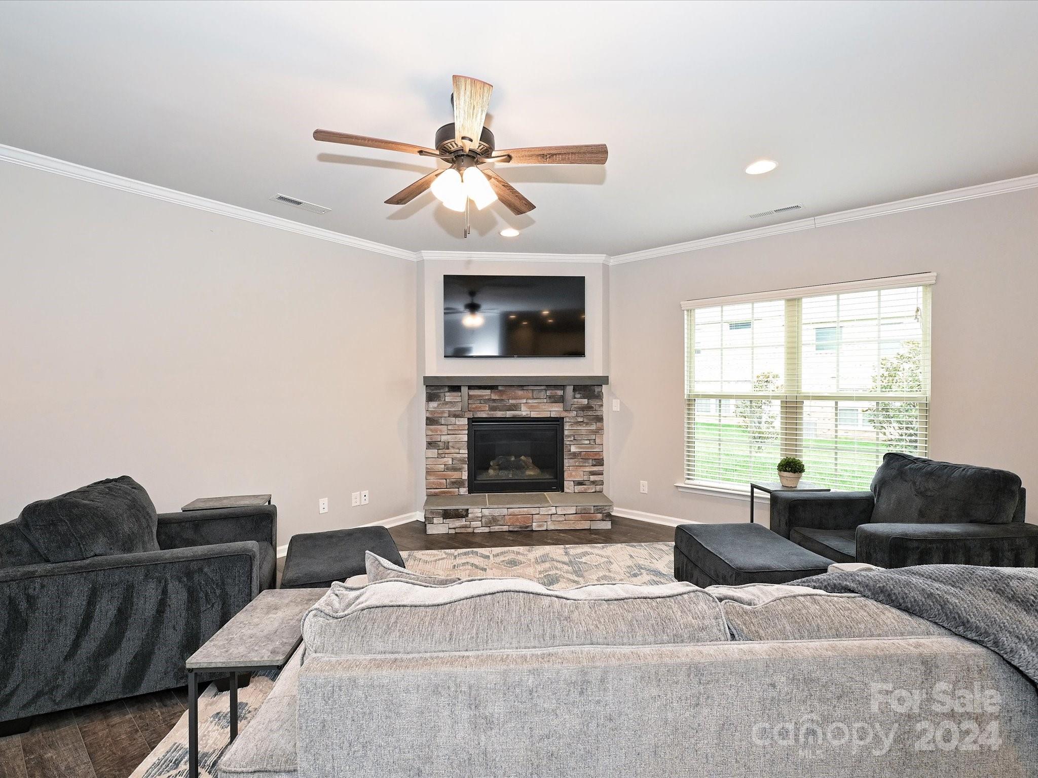 4041 Woodsmill Road Indian Land, SC 29707 - Photo 10 of 36 a living room with furniture a flat screen tv and a fireplace