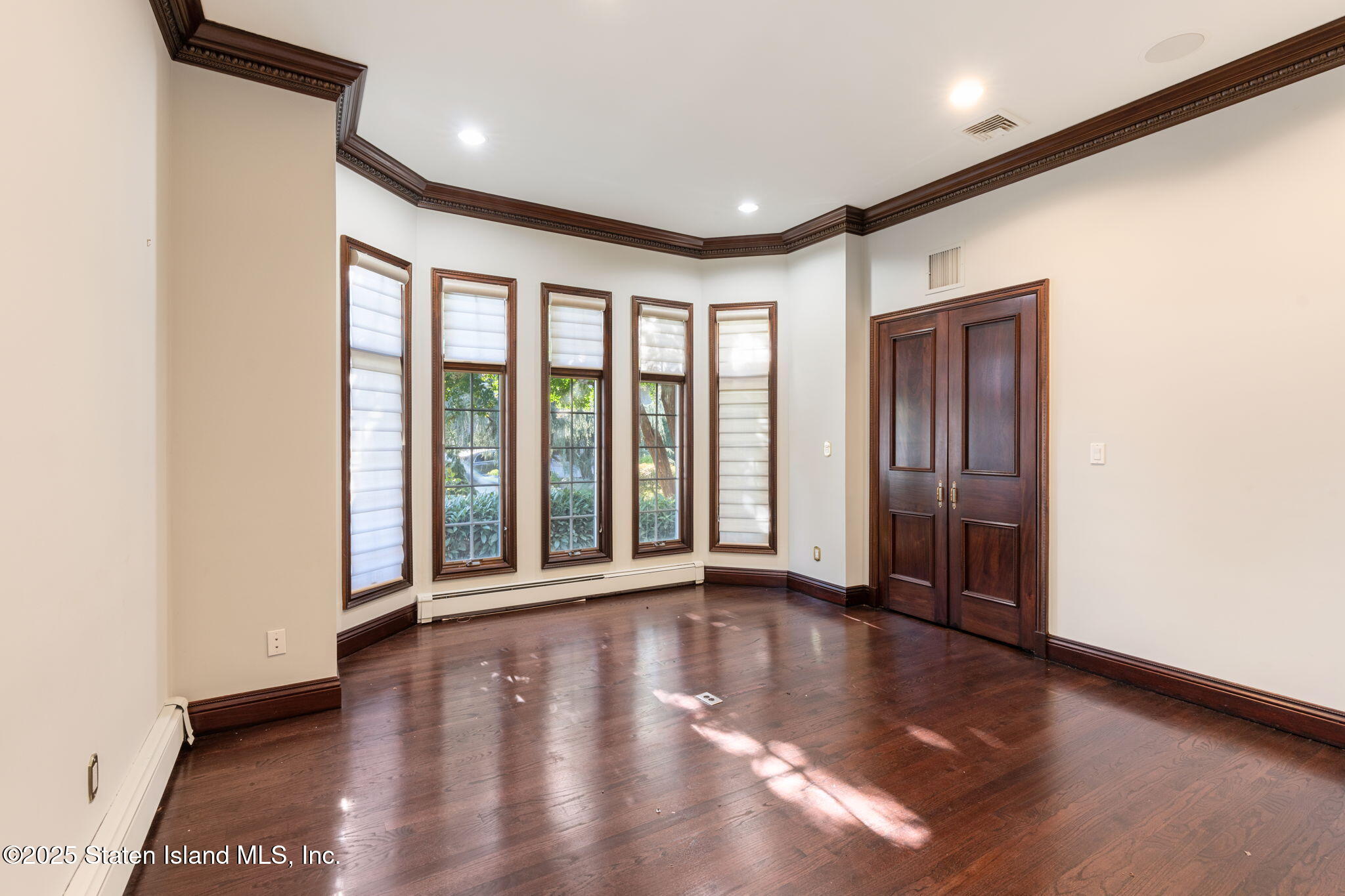 51 Romer Road Staten Island, NY 10304 - Photo 24 of 94 a view of an empty room with wooden floor and a window