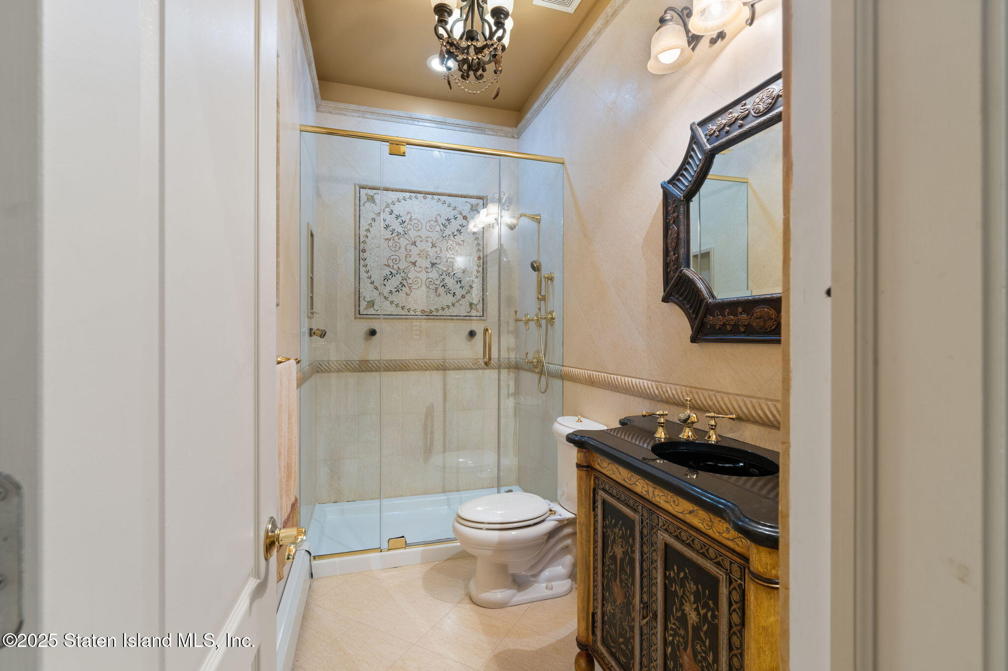 51 Romer Road Staten Island, NY 10304 - Photo 34 of 94 a bathroom with a granite countertop toilet a sink and a mirror