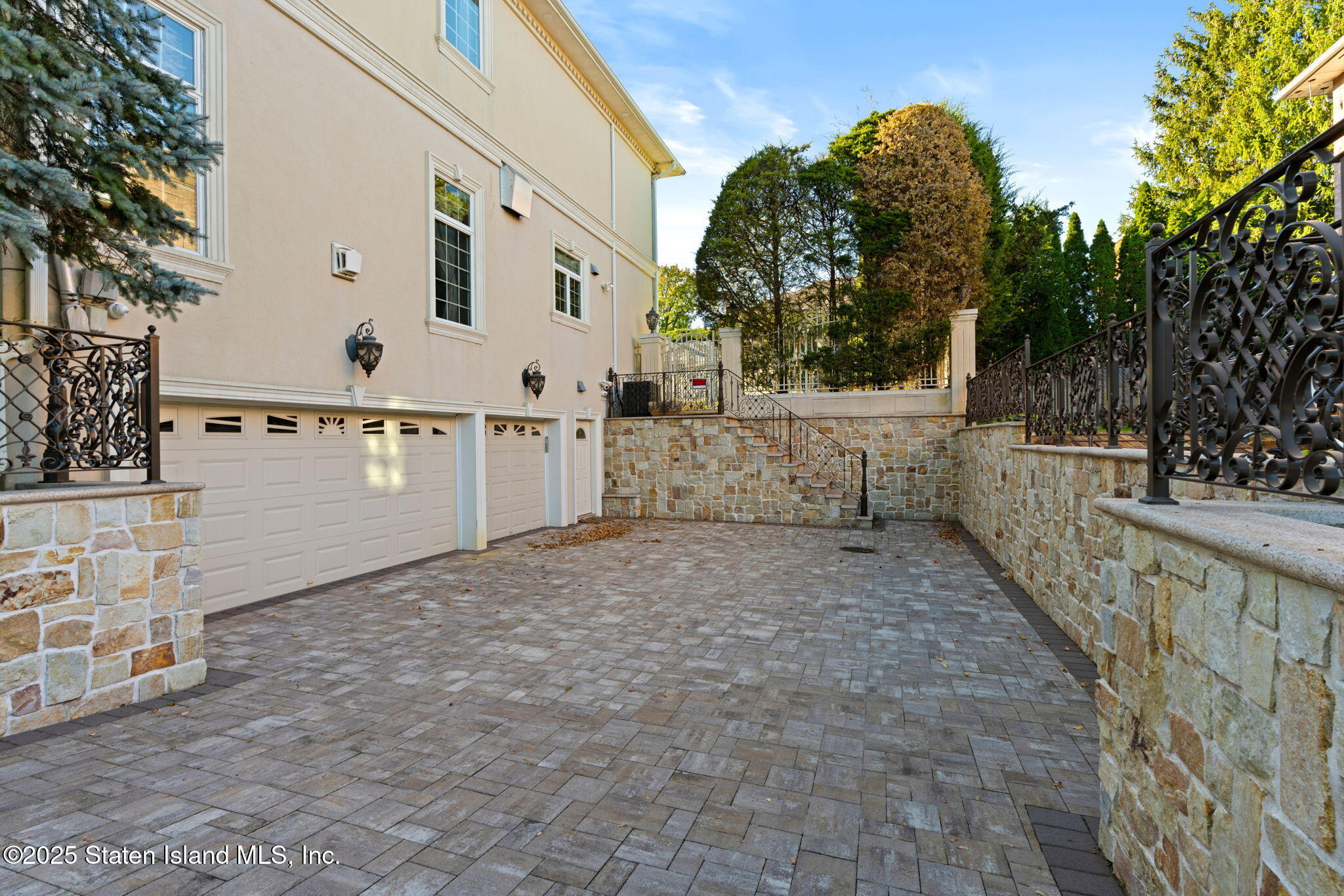51 Romer Road Staten Island, NY 10304 - Photo 8 of 94 a view of a white house with a large tree and a yard