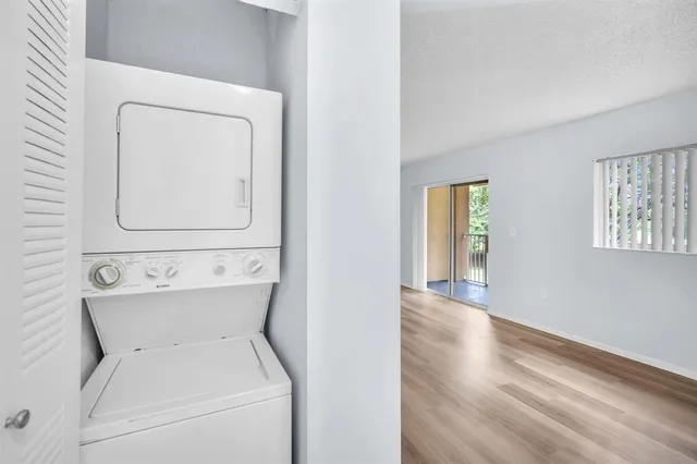 a view of a room with wooden floor and windows