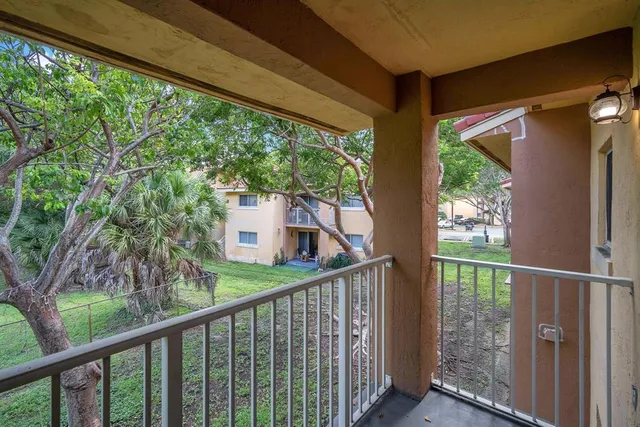a view of a house with a large window and wooden fence