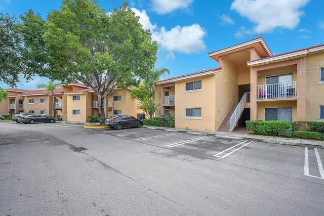 a front view of a house with a yard and a garage