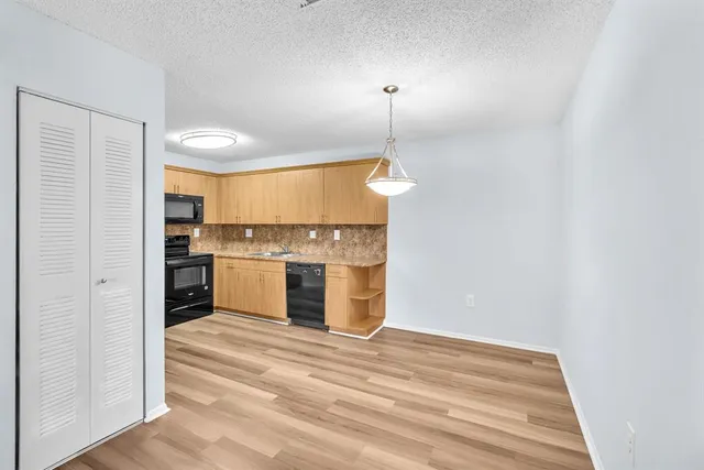 a view of a kitchen with a stove cabinets and a wooden floor
