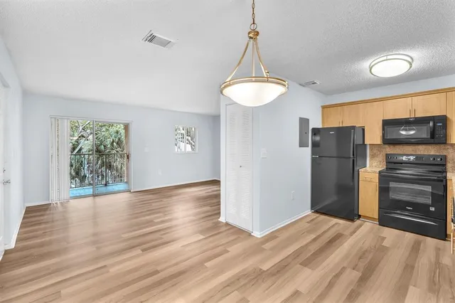 a view of a room with wooden floor and a window