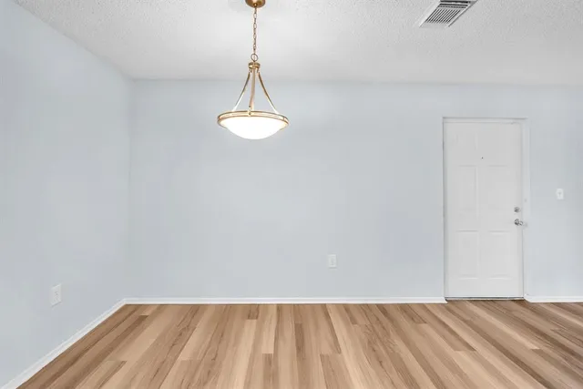 a view of a room with a sink and wooden floor