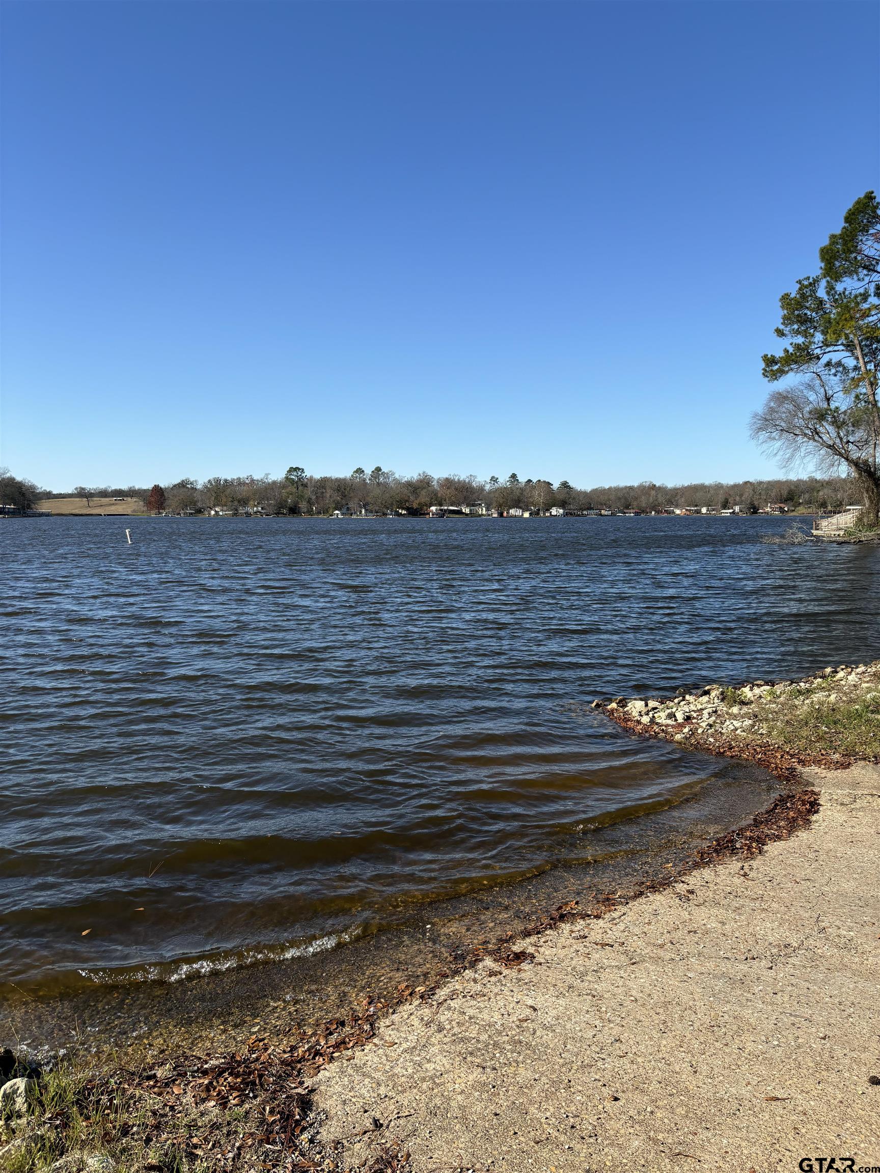 Lot 25 Briar Grove Road Murchison, TX 75778 - Photo 5 of 7 a view of a lake next to a building