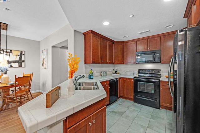 a kitchen with a sink a counter and chairs