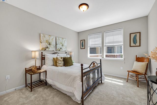 a bedroom with a bed and a lamp on table