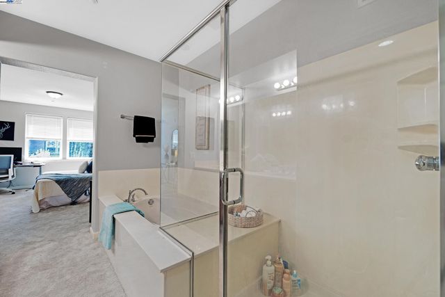 a spacious bathroom with a double vanity sink and a mirror