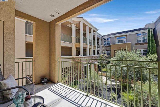 a view of a balcony with furniture