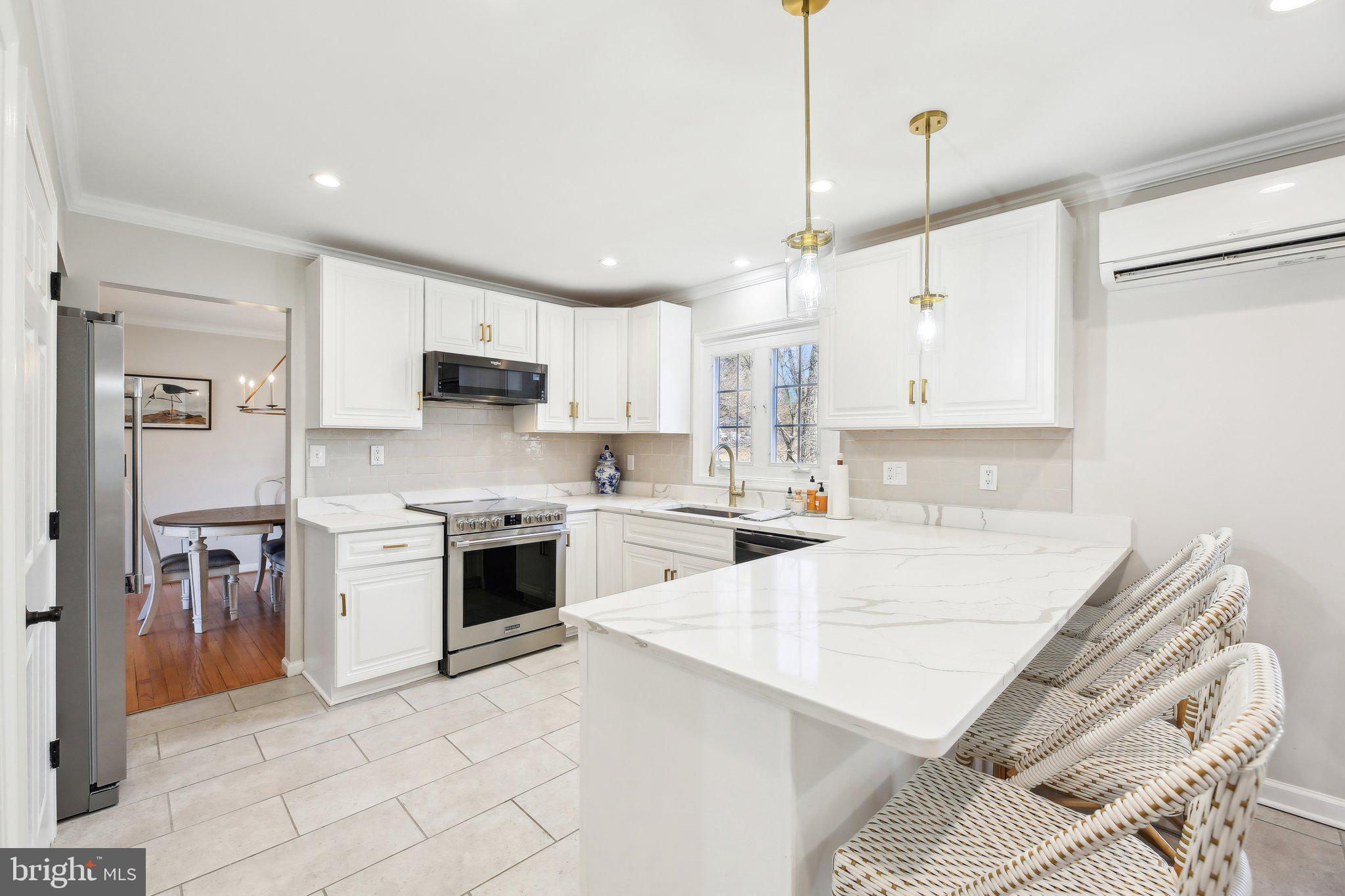 2139 Daisy Road Woodbine, MD 21797 - Photo 12 of 62 a large kitchen with stainless steel appliances kitchen island granite countertop a sink and cabinets