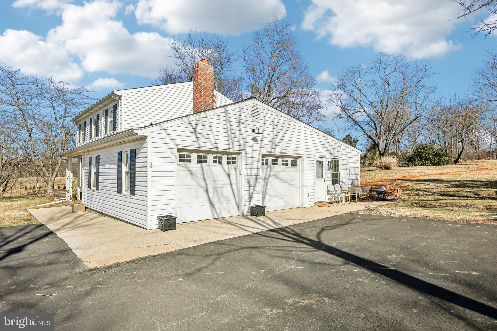 2139 Daisy Road Woodbine, MD 21797 - Photo 4 of 62 a view of a white house with a large trees next to a yard