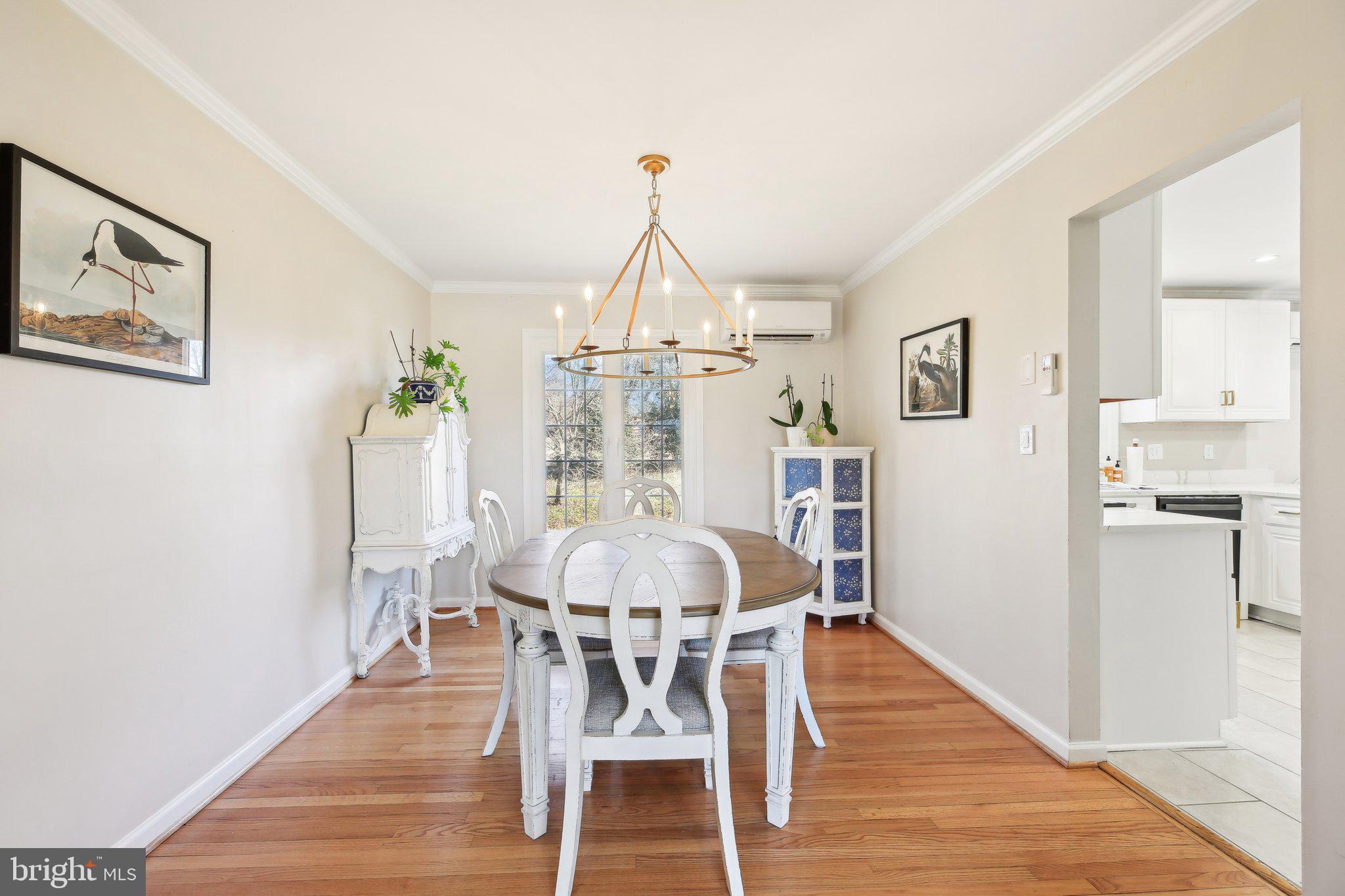 2139 Daisy Road Woodbine, MD 21797 - Photo 10 of 62 a dining room with furniture a chandelier and wooden floor