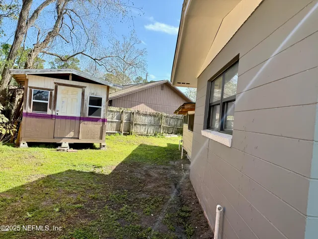 a view of house with backyard