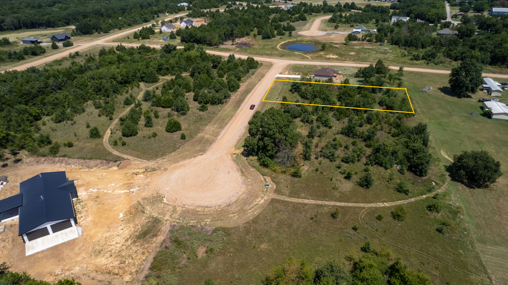0 Redbird Lane Colbert, OK 74733 - Photo 5 of 6 Expansive acreage featuring mature tree coverage, rolling terrain, and established landscaping with defined property boundaries