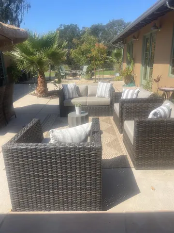 a view of house with backyard outdoor seating and plants