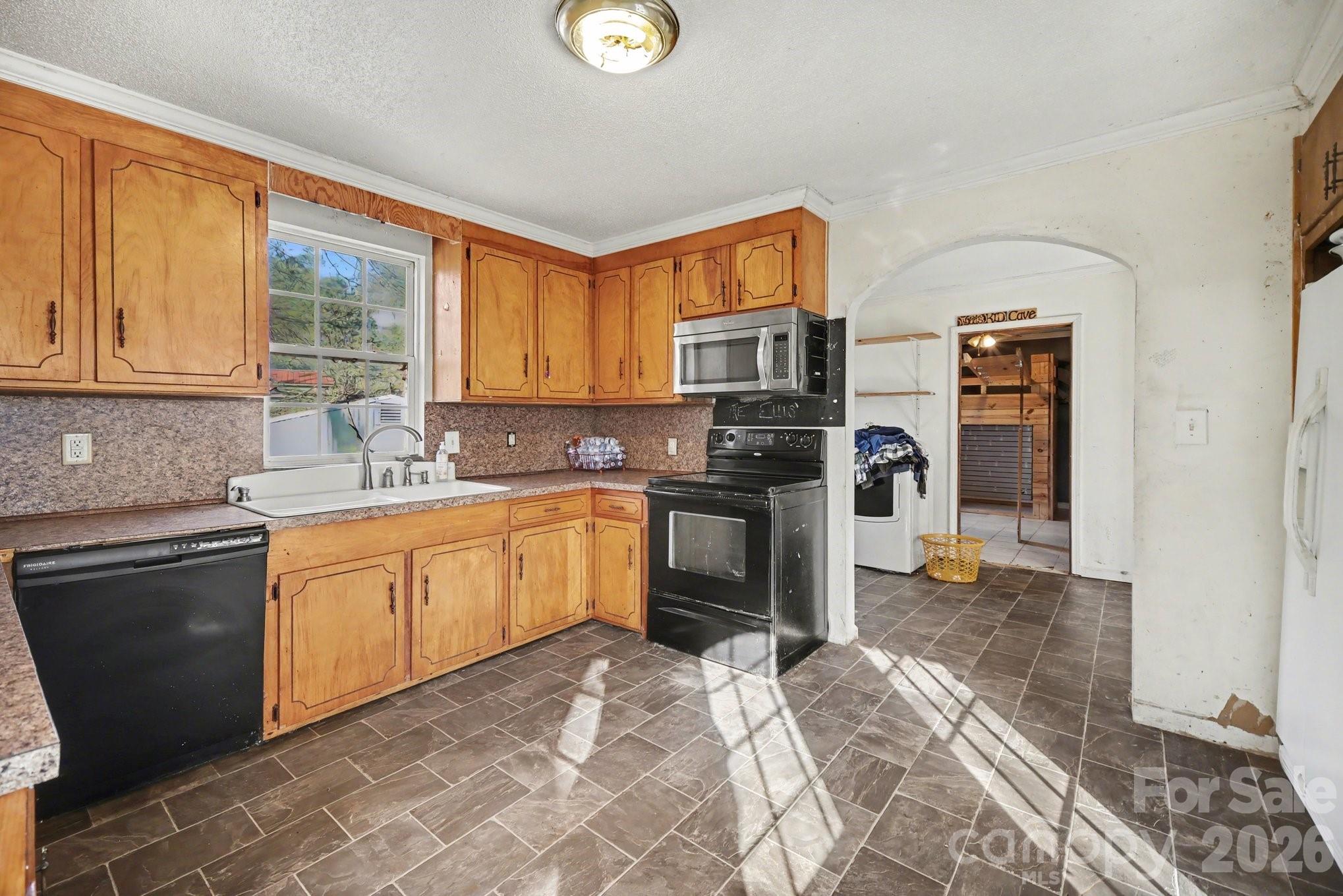 453 Robert Road Cherryville, NC 28021 - Photo 16 of 36 a kitchen with a sink cabinets stainless steel appliances and a window