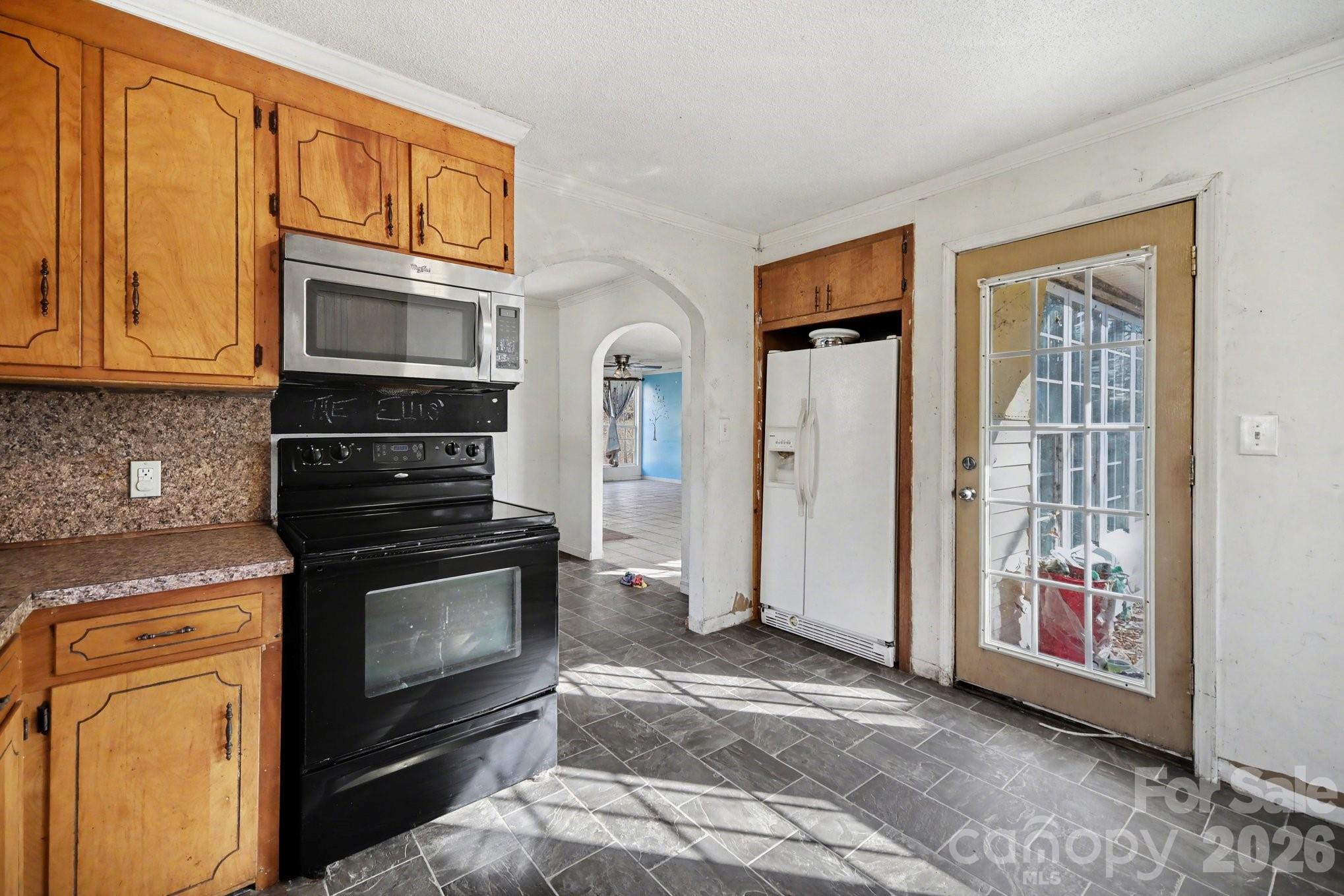 453 Robert Road Cherryville, NC 28021 - Photo 18 of 36 a kitchen with granite countertop cabinets stainless steel appliances and a window
