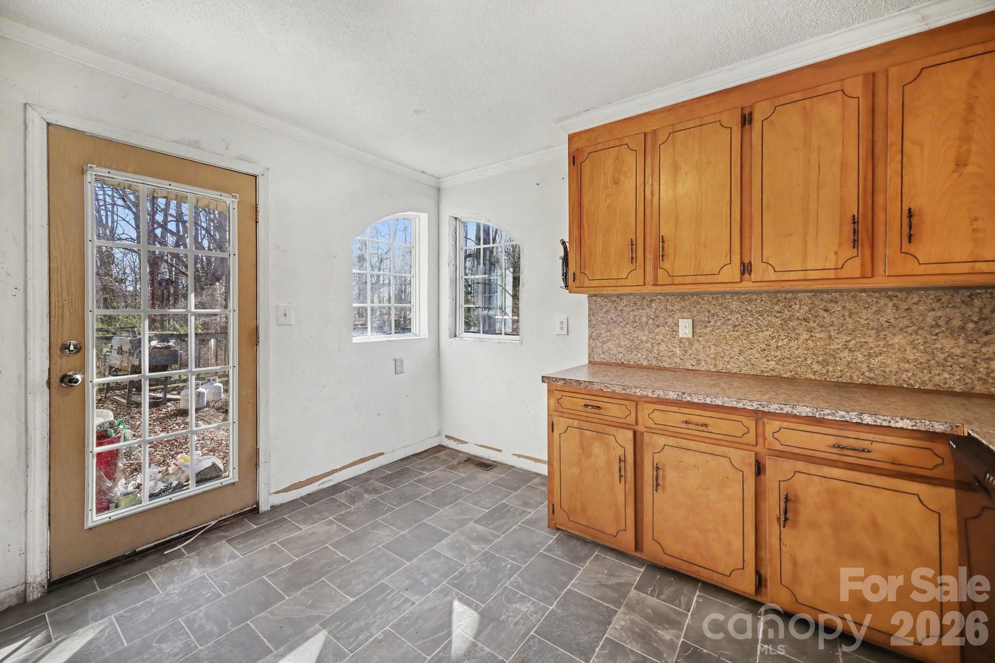 453 Robert Road Cherryville, NC 28021 - Photo 19 of 36 a kitchen with granite countertop cabinets and window