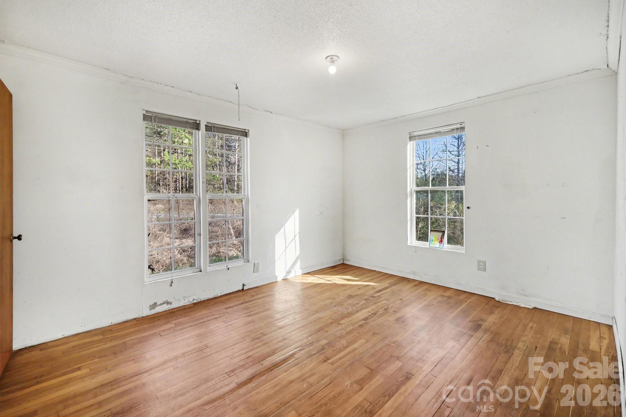 453 Robert Road Cherryville, NC 28021 - Photo 20 of 36 an empty room with wooden floor and windows