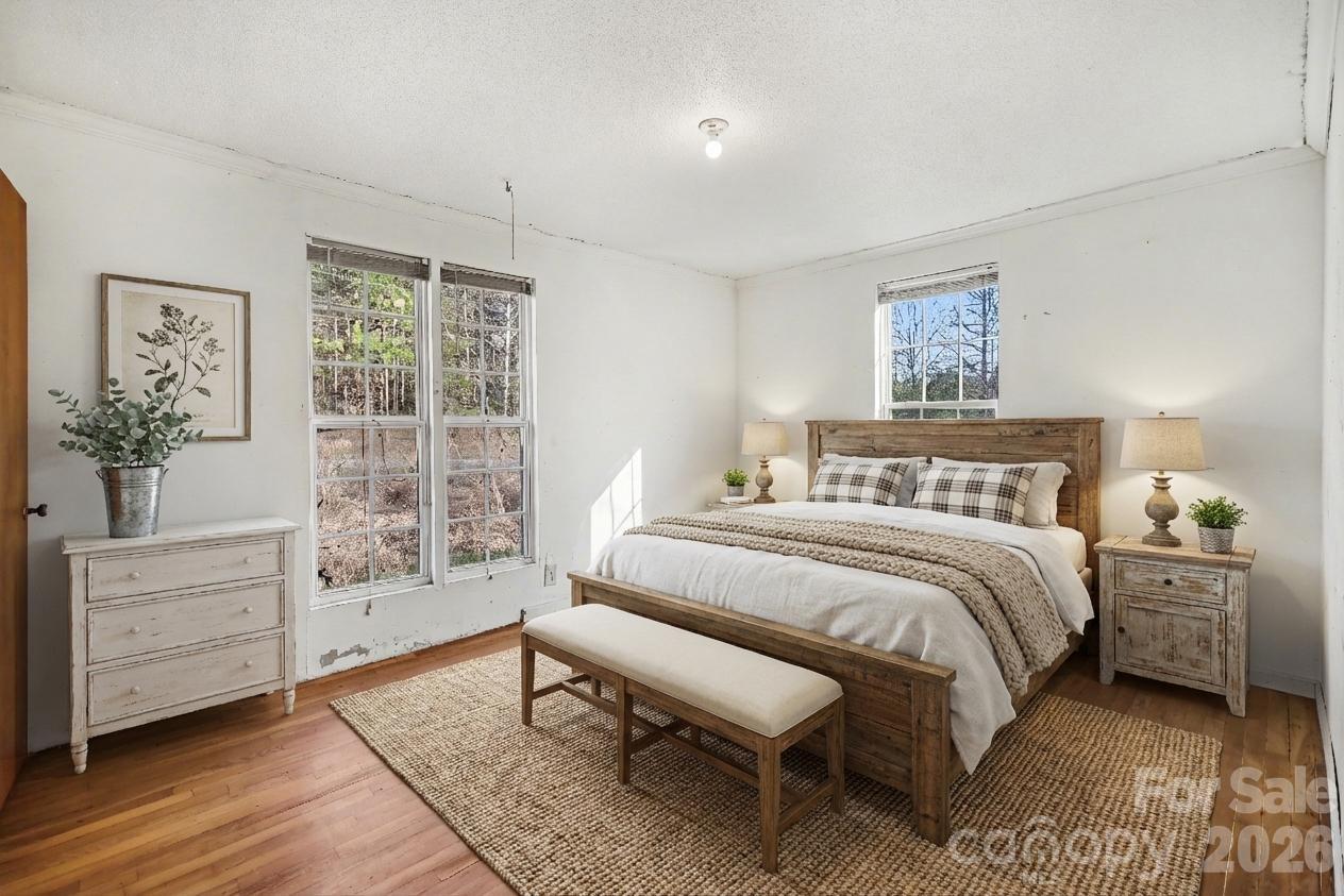 453 Robert Road Cherryville, NC 28021 - Photo 21 of 36 a spacious bedroom with a bed a dresser and next to a window