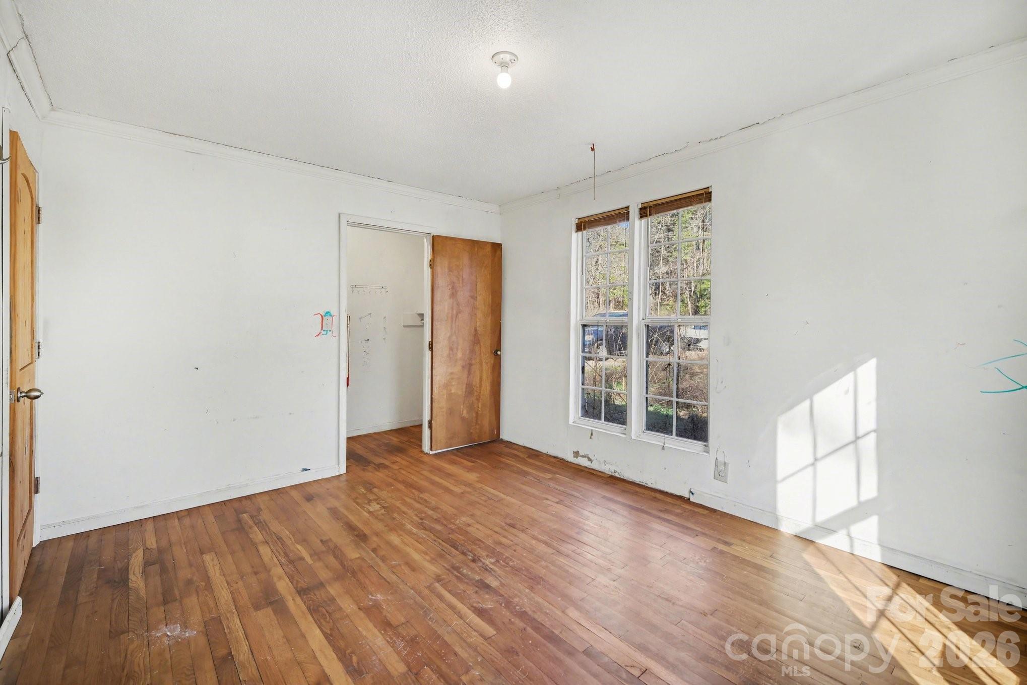 453 Robert Road Cherryville, NC 28021 - Photo 23 of 36 a view of an empty room with wooden floor and a window