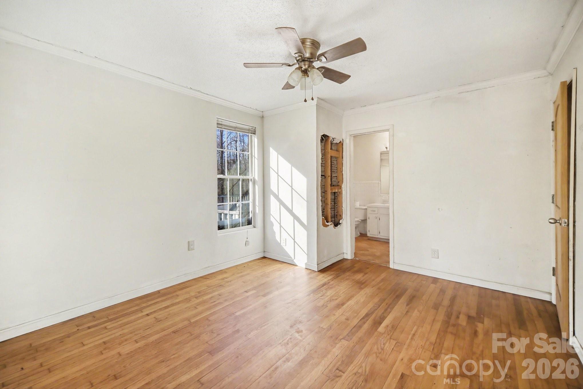 453 Robert Road Cherryville, NC 28021 - Photo 27 of 36 an empty room with wooden floor and ceiling fan
