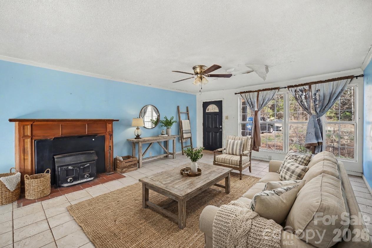 453 Robert Road Cherryville, NC 28021 - Photo 7 of 36 a living room with furniture a fireplace and a table