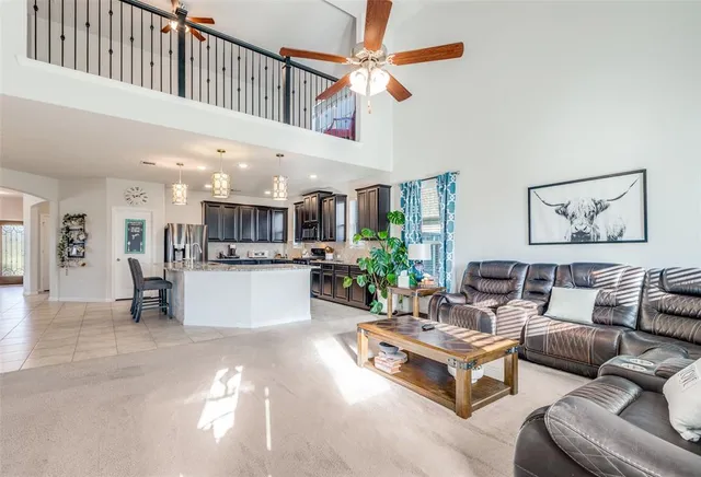 a living room with furniture kitchen view and a potted plant