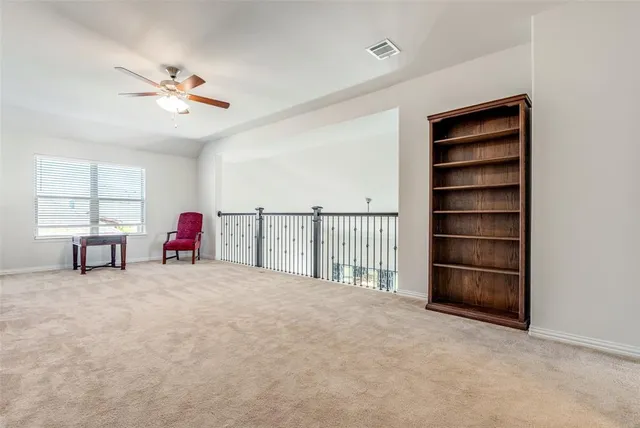a view of a livingroom with furniture and a chandelier fan