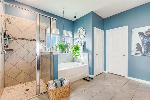 a spacious bathroom with double vanity and a mirror