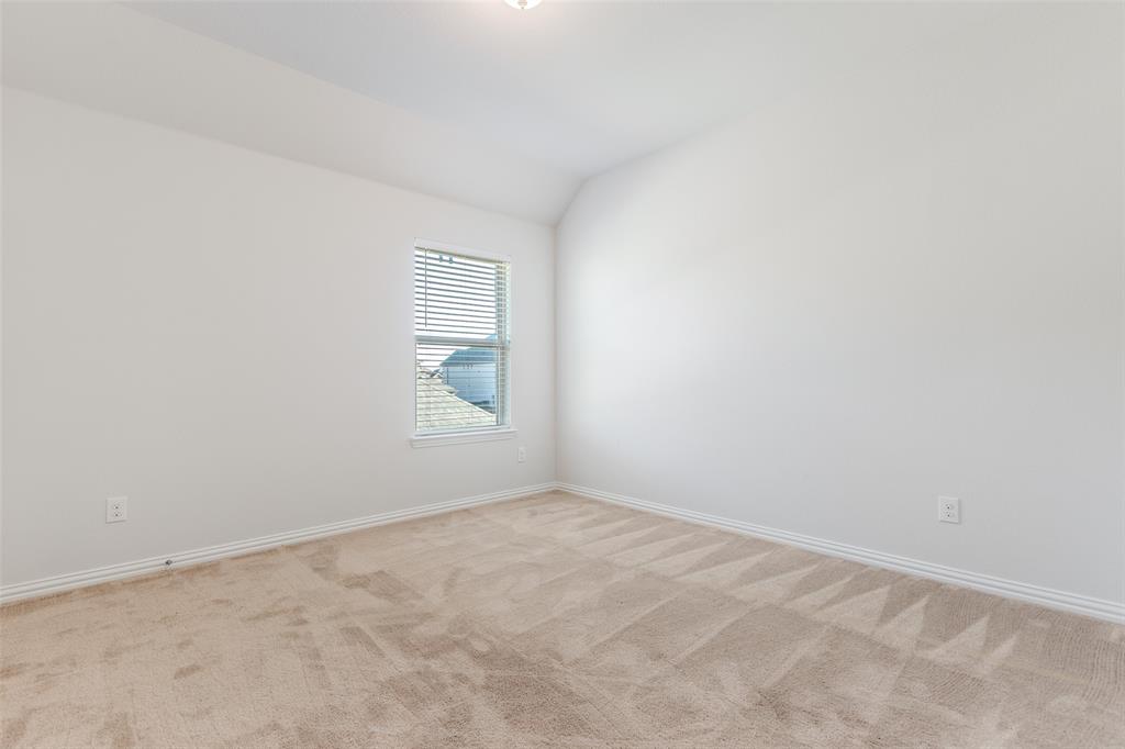 4542 Kipling Avenue Aubrey, TX 76227 - Photo 27 of 36 Carpeted empty room featuring lofted ceiling and baseboards