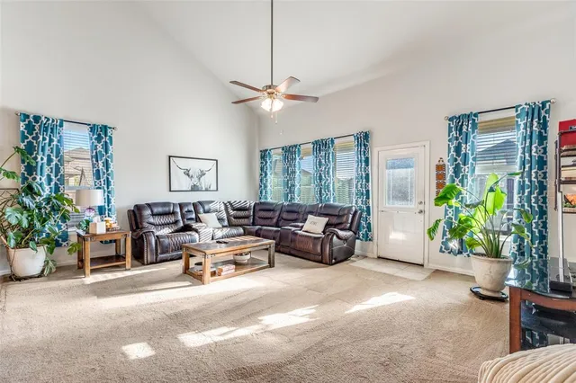 a living room with furniture potted plant and a chandelier