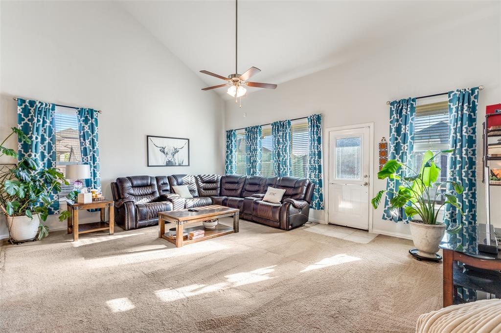 4542 Kipling Avenue Aubrey, TX 76227 - Photo 9 of 36 Carpeted living area with high vaulted ceiling, plenty of natural light, and a ceiling fan