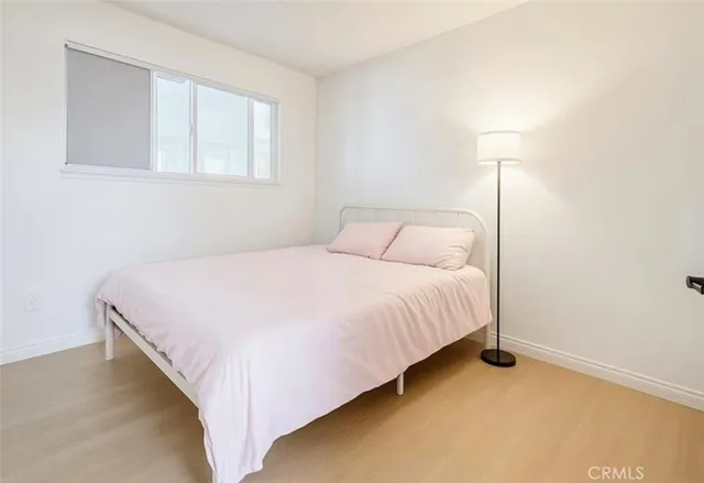 a bedroom with a bed and a night stand