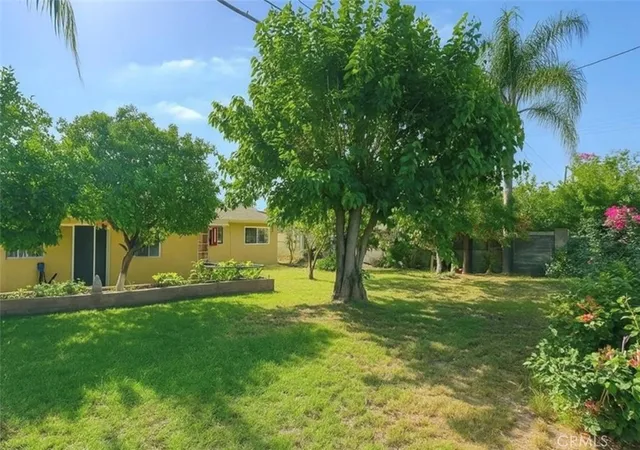 a backyard of a house with table and chairs